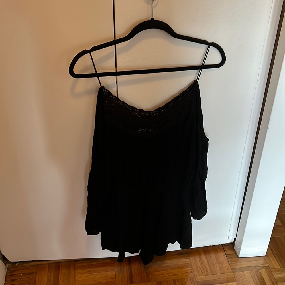 Black romper with lace neckline and a cold shoulder